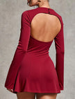 White backless long-sleeved slim-fit dress by FJØRNA, shown from the side with a sleek, elegant silhouette.