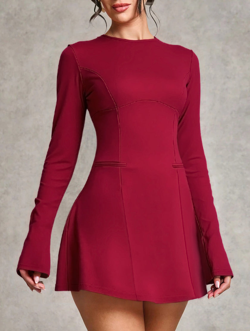 White backless long-sleeved slim-fit dress by FJØRNA, showcasing a sleek silhouette and elegant design.