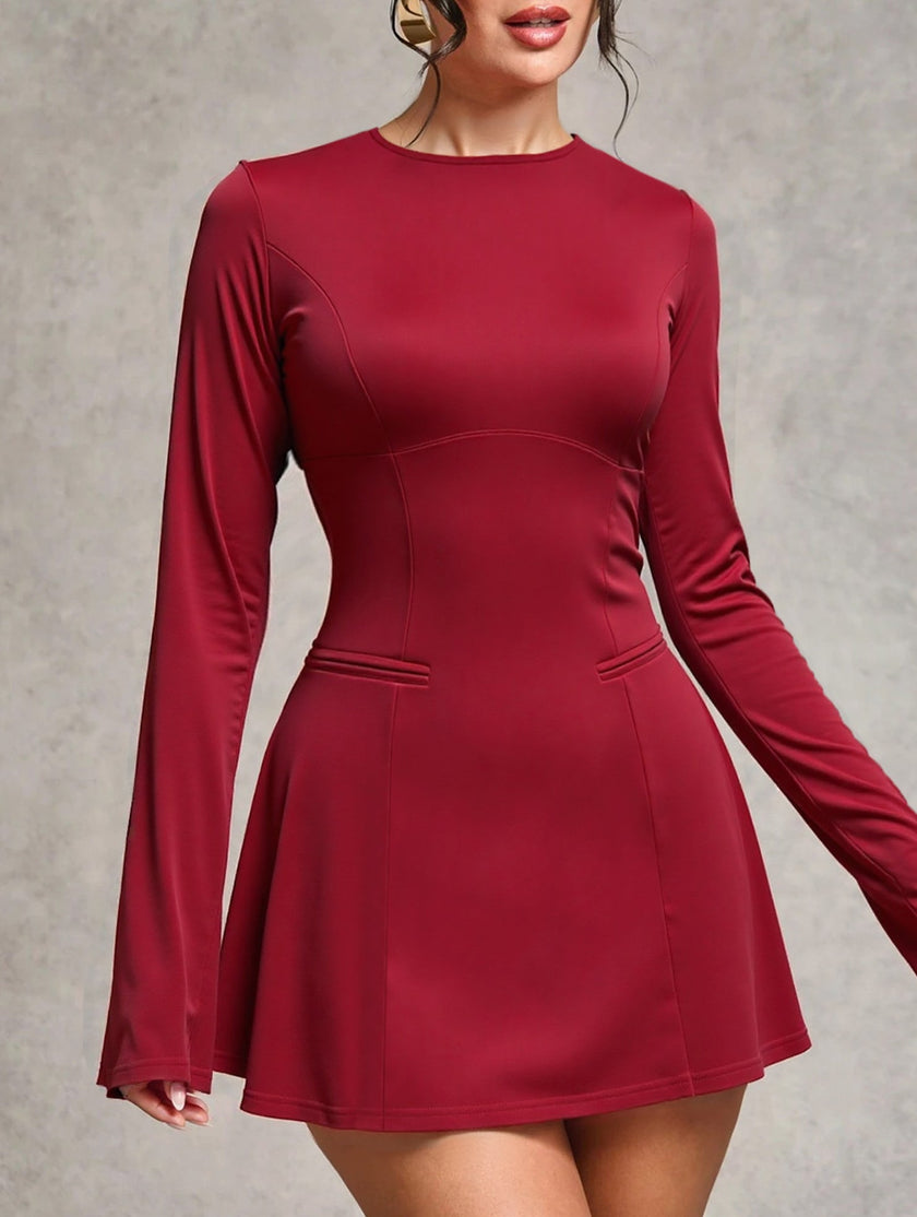 White backless long-sleeved slim-fit dress by FJØRNA, showcasing a sleek silhouette and elegant design.