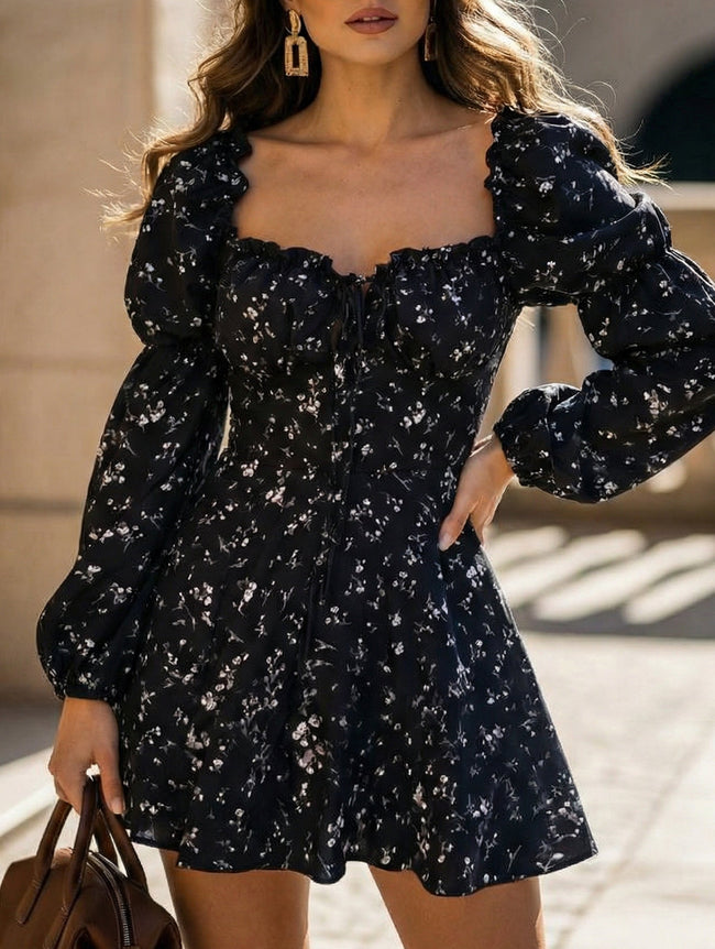 FJØRNA floral print fitted waist dress for women, elegant black dress with vibrant floral pattern, sleeveless design.
