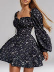 Black floral print fitted waist dress for women by FJØRNA, showcasing elegant floral design and tailored fit.
