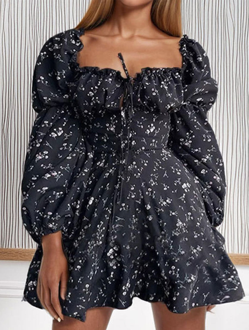 Elegant floral print fitted waist dress for women by FJØRNA, featuring a stylish floral pattern and fitted silhouette in black.