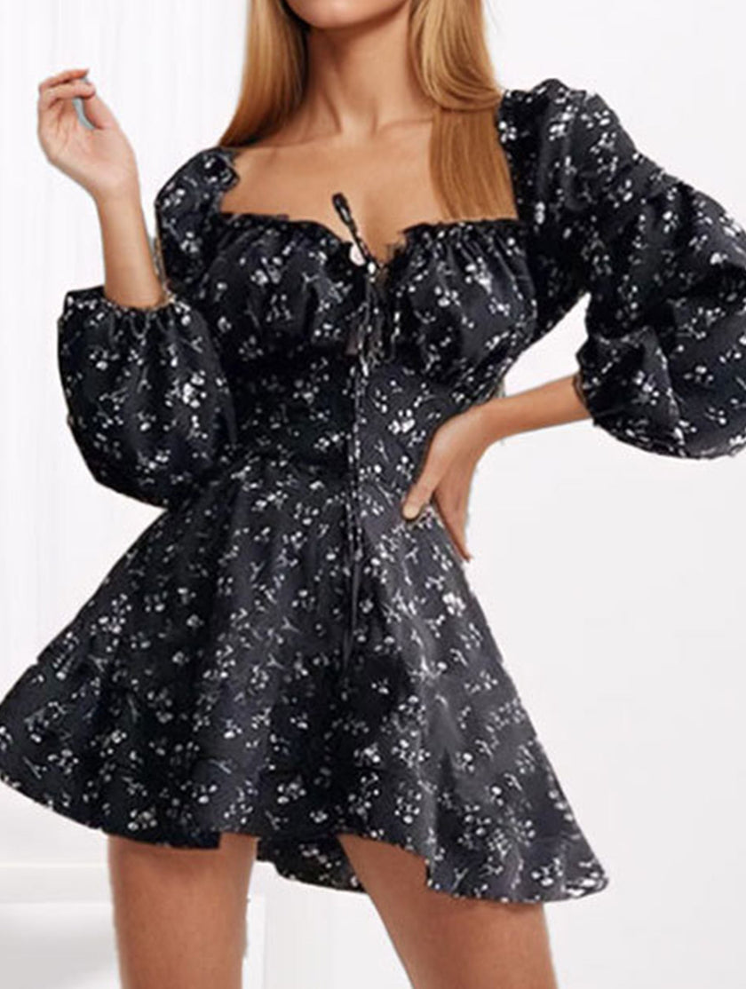 Black floral print fitted waist dress for women by FJØRNA, showcasing elegant floral pattern and tailored fit.