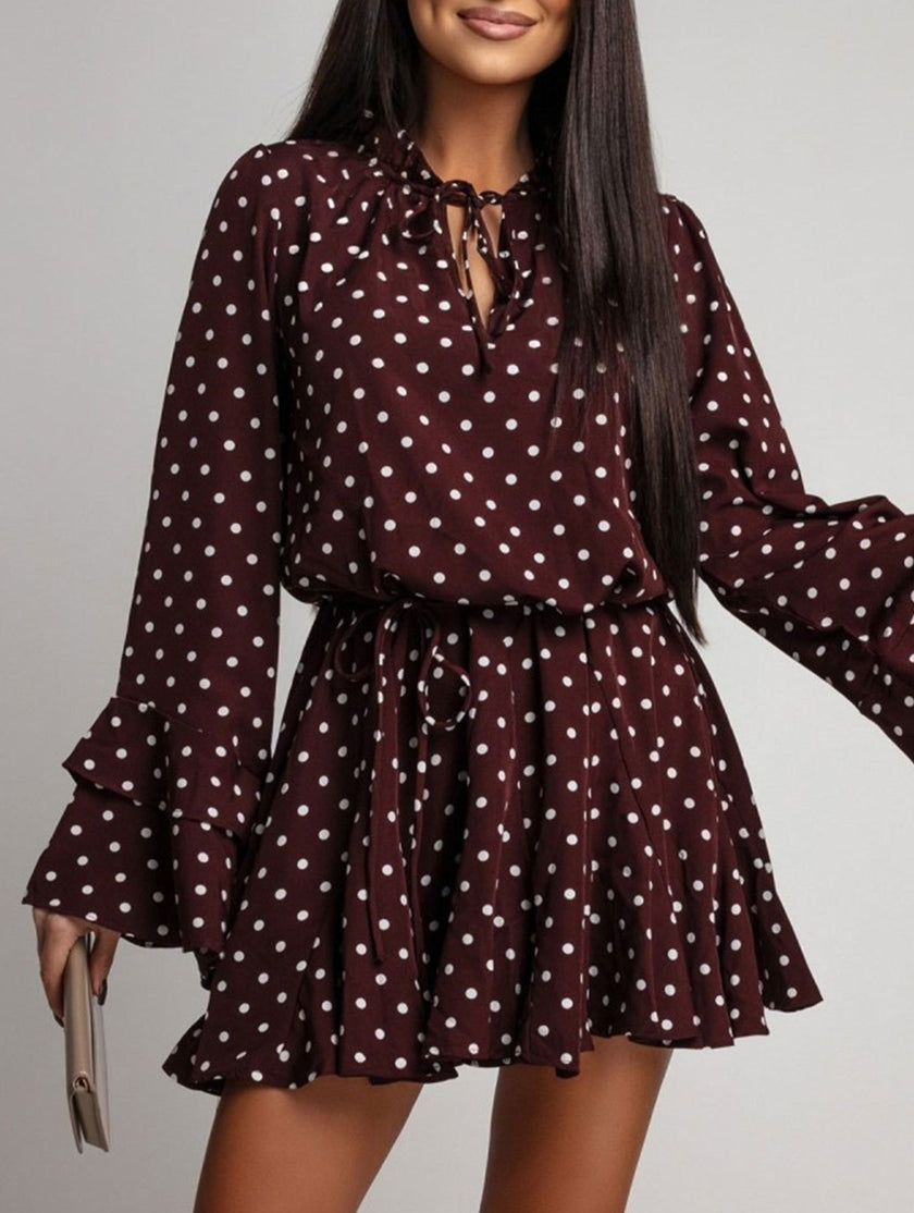 Dark brown polka dot V-neck long sleeve midi dress by FJØRNA, featuring a classic white polka dot pattern and a flattering silhouette.