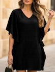Black solid loose ruffle V-neck flowy dress by FJØRNA, featuring a relaxed fit and elegant ruffle details in a flowy style.