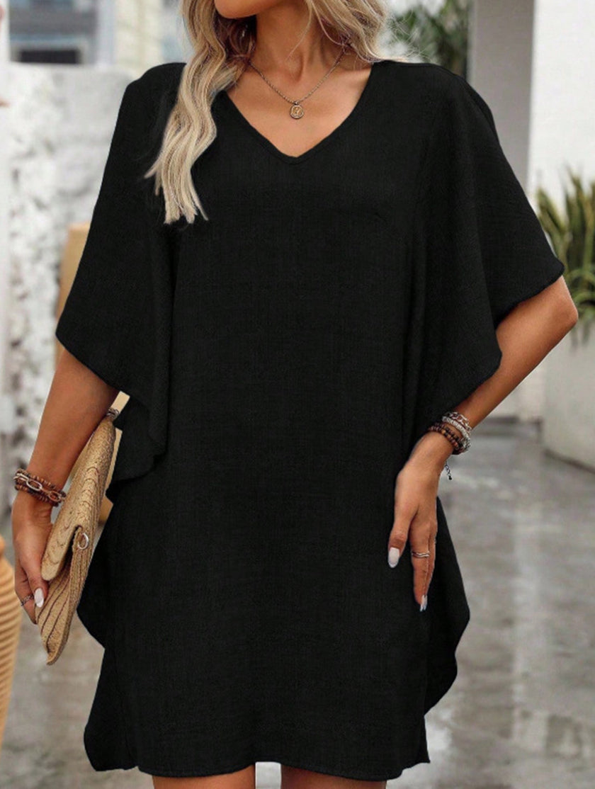 Black FJØRNA solid loose ruffle V-neck flowy dress with long sleeves, featuring a relaxed fit and elegant design.