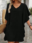 Black FJØRNA solid loose ruffle V-neck flowy dress featuring a relaxed fit and elegant ruffle details.