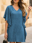 Blue FJØRNA solid loose ruffle V-neck flowy dress with a relaxed fit and ruffled details, perfect for casual or special occasions.