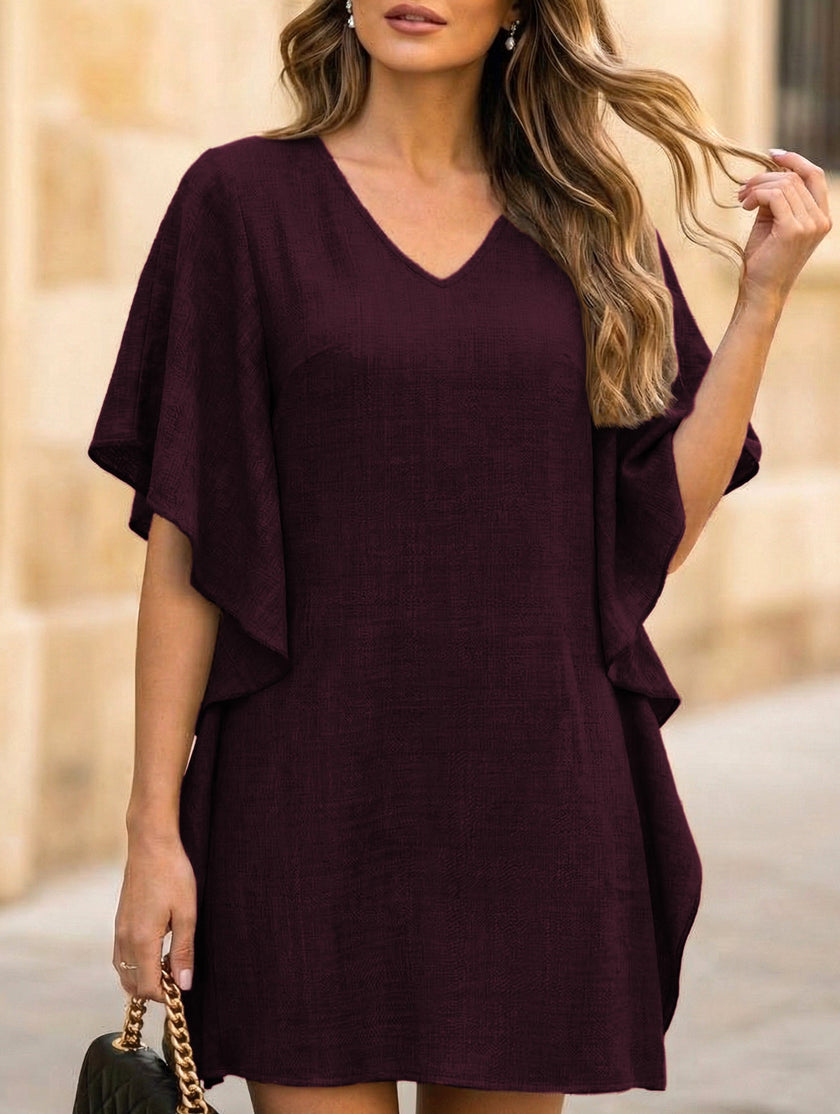 White FJØRNA solid loose ruffle V-neck flowy dress with a relaxed fit and elegant design, perfect for casual or semi-formal wear.