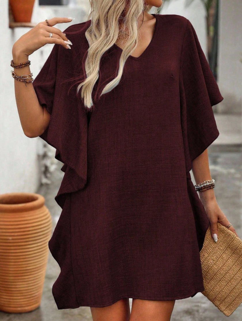 White FJØRNA solid loose ruffle V-neck flowy dress with a relaxed fit and elegant design, perfect for casual or semi-formal occasions.