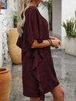 White FJØRNA solid loose ruffle V-neck flowy dress displayed on a hanger with soft fabric details.