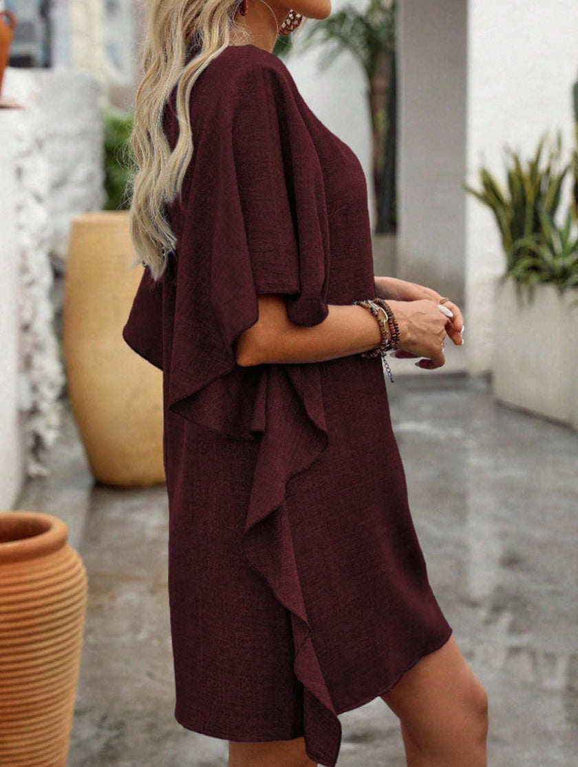 White FJØRNA solid loose ruffle V-neck flowy dress displayed on a hanger with soft fabric details.