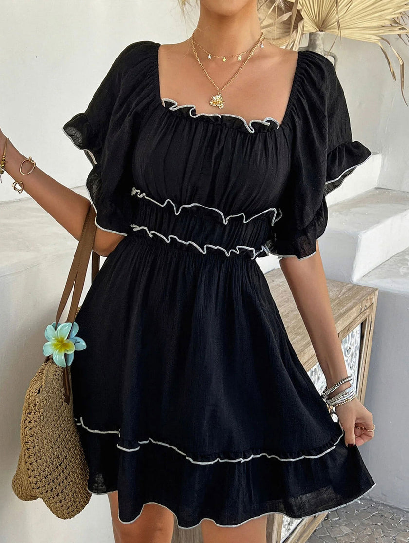 FJØRNA white French square neck ruffle A-line dress displayed on a hanger, showcasing its elegant design and flowing fabric.