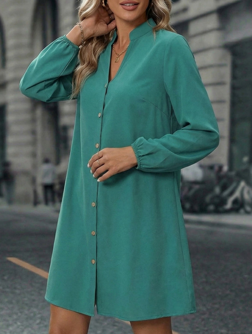 FJØRNA white solid long sleeve A-line midi dress displayed on a hanger, showcasing its elegant design and smooth fabric.