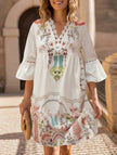 White V-neck lace patch print dress by FJØRNA, featuring a stylish design and delicate lace details.