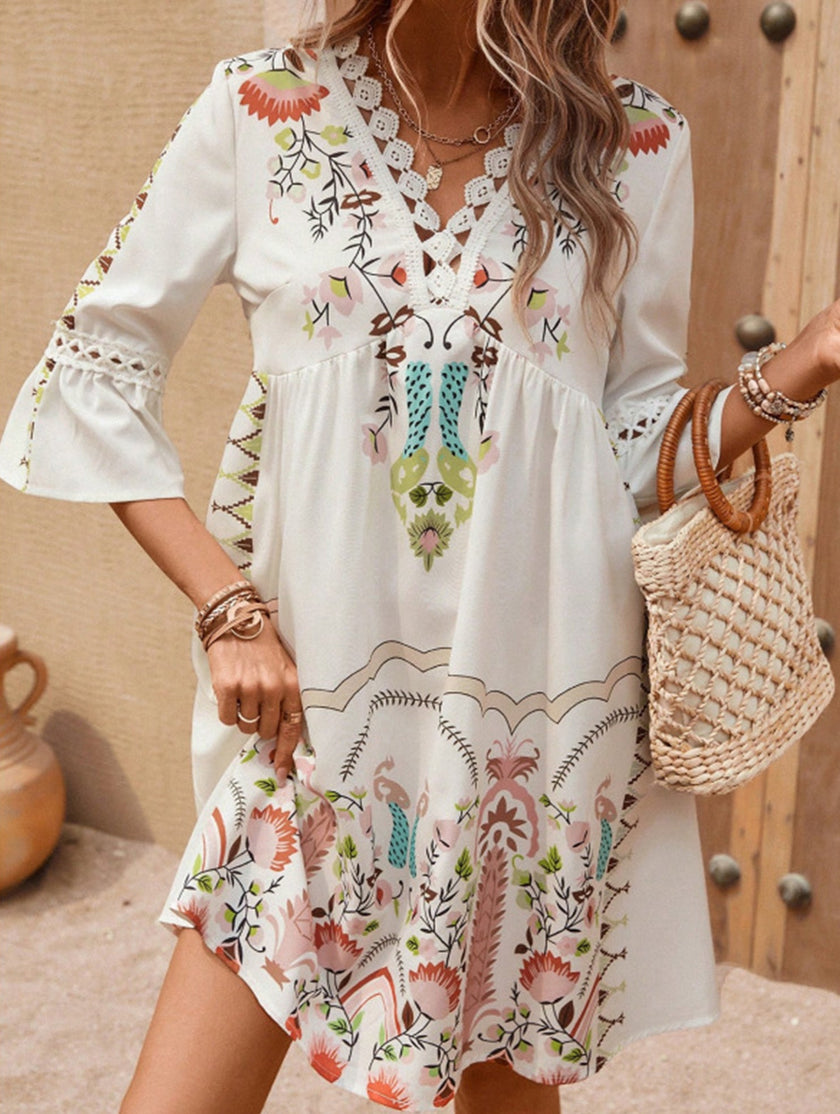 White V-neck lace patch print dress by FJØRNA, featuring delicate lace details and a stylish, feminine design.