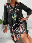 Black V neck lace patch print dress by FJØRNA, featuring elegant design and detailed lace accents.