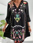 Black V-neck lace patch print dress by FJØRNA, featuring a stylish design with intricate lace details and a classic silhouette.