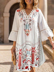 White V-neck lace patch print dress by FJØRNA, featuring a stylish design and elegant fit, shown on a model.