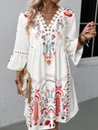 FJØRNA white V-neck lace patch print dress with floral details, featuring a flowy silhouette and elegant design.