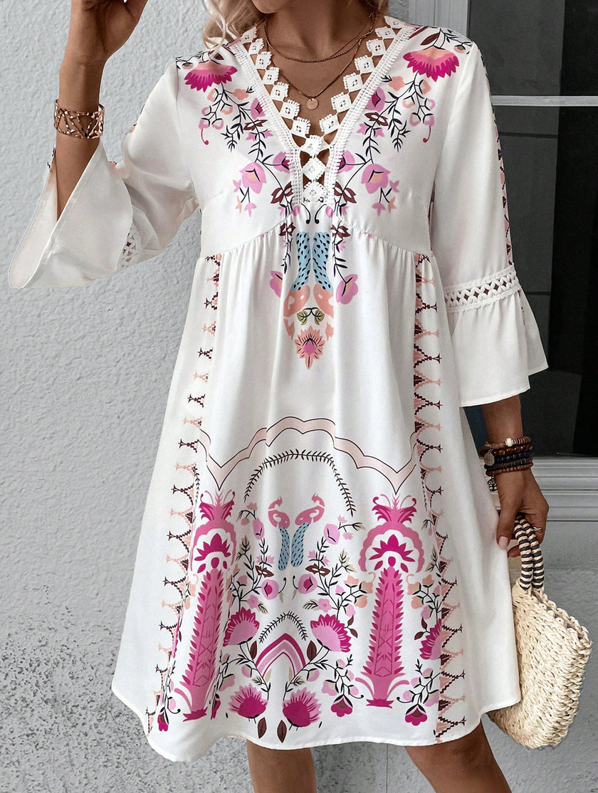 White V-neck lace patch print dress by FJØRNA featuring a flowy silhouette and elegant design.