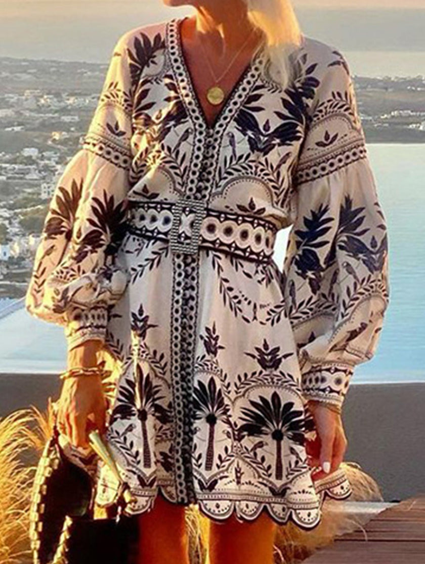 Black printed beach mini dress by FJØRNA, lightweight fabric with stylish pattern, perfect for summer or casual beach outings.