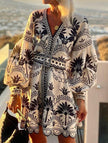 Black printed FJØRNA beach mini dress featuring lightweight fabric and stylish design, perfect for summer outings.