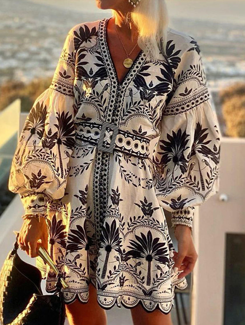 Black printed FJØRNA beach mini dress featuring lightweight fabric and stylish design, perfect for summer outings.
