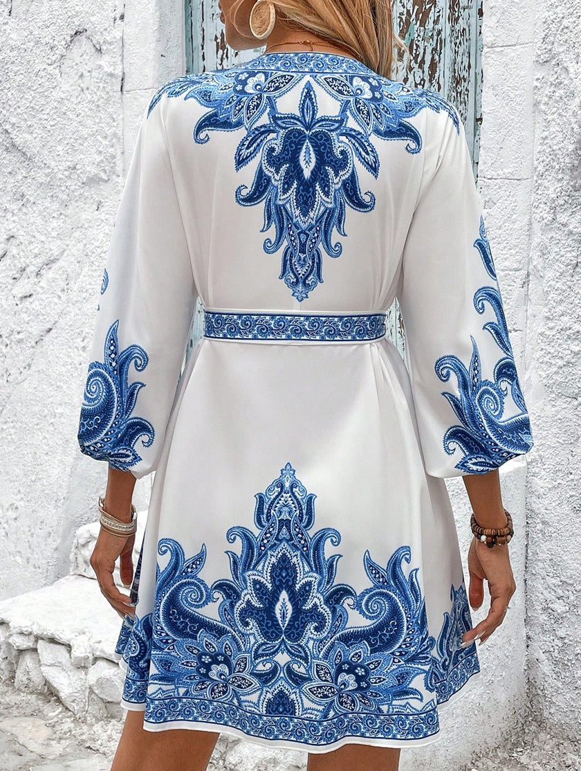 FJØRNA blue tie waist print midi dress featuring a stylish design and flowing fabric, perfect for elegant daytime wear.