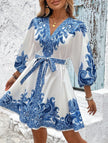 FJØRNA tie waist print midi dress in white with blue patterns, featuring a flattering silhouette and elegant midi length.