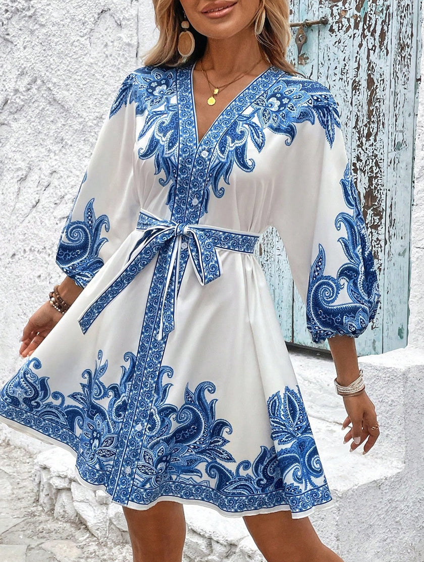 FJØRNA tie waist print midi dress in white with blue patterns, featuring a flattering silhouette and elegant midi length.