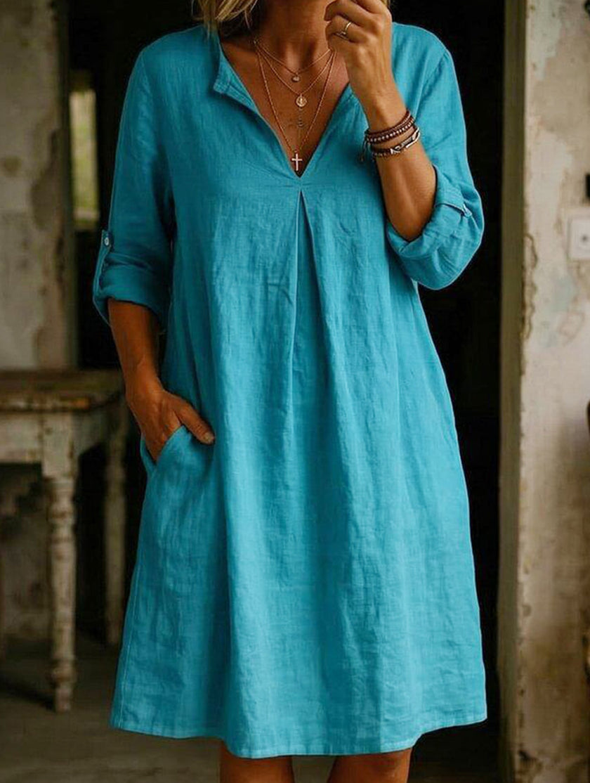 White linen V-neck short sleeve dress by FJØRNA, shown with a relaxed fit and lightweight fabric perfect for warm weather.