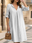 White linen V-neck short sleeve dress by FJØRNA, showcasing a flowy, relaxed fit perfect for warm weather.