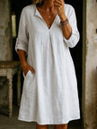 White linen V-neck short sleeve dress by FJØRNA, lightweight and breezy with a relaxed fit, perfect for warm weather.