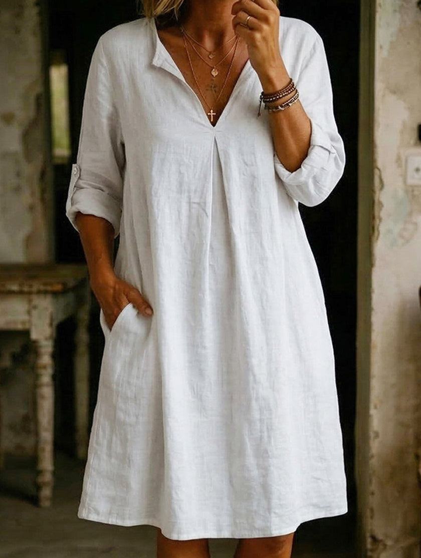 White linen V-neck short sleeve dress by FJØRNA, lightweight and breezy with a relaxed fit, perfect for warm weather.