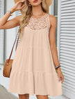 FJØRNA lace patch halter A-line dress in apricot color, featuring a fitted bodice and flowing skirt with lace details.