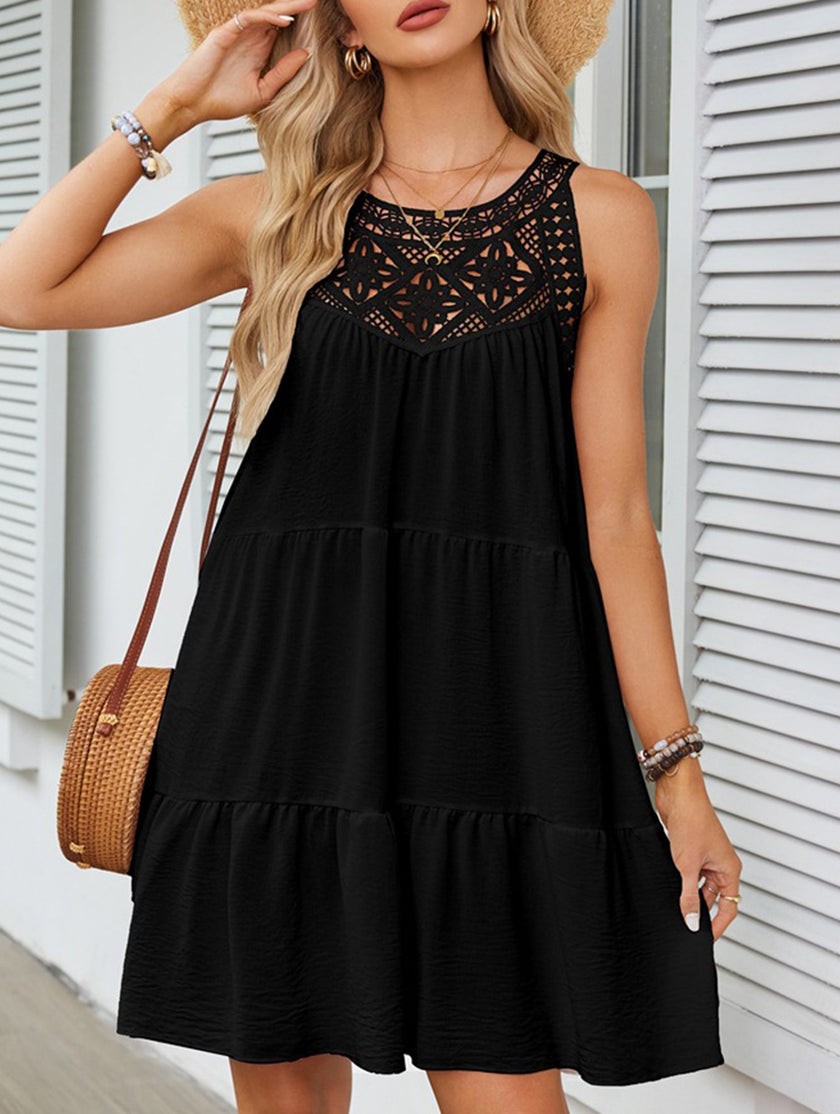 Black lace patch halter A-line dress by FJØRNA, featuring a stylish neckline and flowing silhouette, shown on a model.