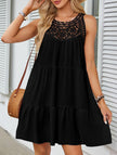Black lace patch halter A-line dress by FJØRNA, featuring a fitted bodice and flowing skirt, shown on a model.