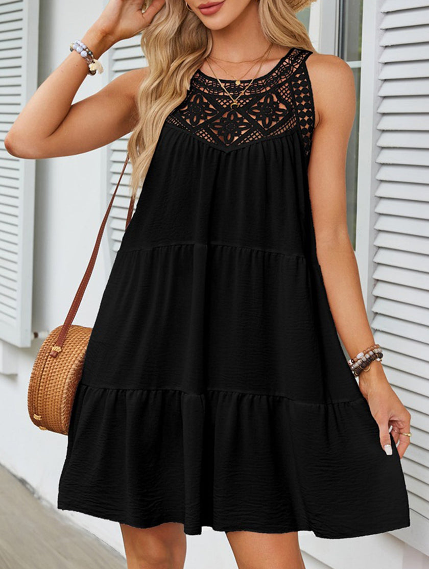 Black lace patch halter A-line dress by FJØRNA, featuring a fitted bodice and flowing skirt, shown on a model.
