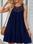 Navy lace patch halter A-line dress by FJØRNA, featuring a fitted bodice and flowing skirt, displayed on a hanger.