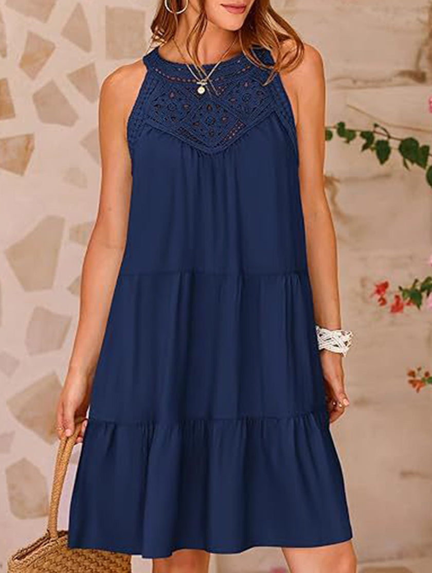 Navy lace patch halter A-line dress by FJØRNA displayed on a hanger, showcasing its elegant lace details and classic silhouette.