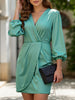 FJØRNA elegant solid white V-neck dress displayed on a hanger, showcasing its simple, stylish design and smooth fabric.
