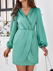 White V-neck dress by FJØRNA, elegant solid color dress made from smooth fabric, shown on a hanger.