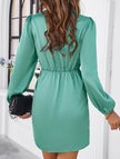 Elegant white V-neck dress by FJØRNA featuring a solid color design and smooth fabric, perfect for stylish occasions.