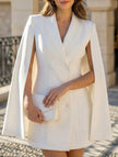 FJØRNA white double-breasted cape blazer dress, stylish and elegant, shown on a model with a fitted silhouette and classic design.