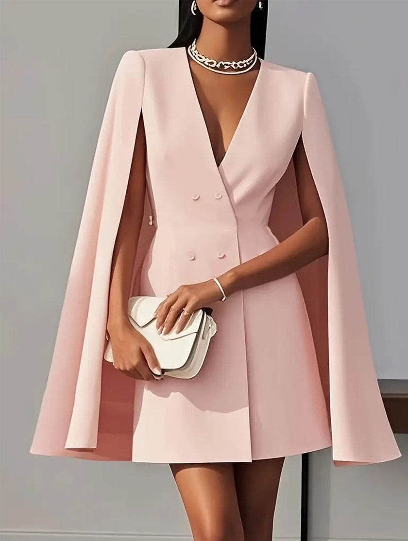 FJØRNA white double-breasted cape blazer dress displayed on a hanger, showcasing the stylish design and elegant silhouette.
