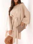FJØRNA white round neck flare sleeve belted dress displayed on a hanger, showcasing a stylish and elegant design.