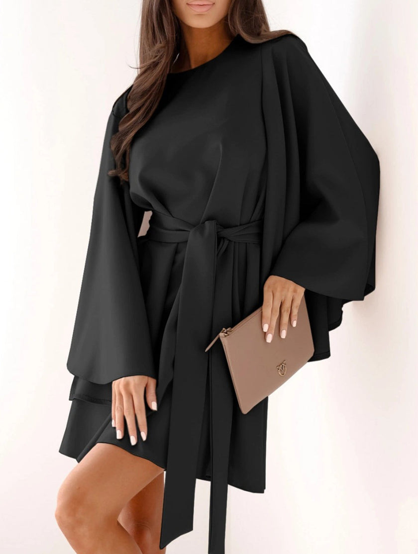 FJØRNA white round neck flare sleeve belted dress, stylish and elegant, shown on a model with a fitted waist and flowing skirt.