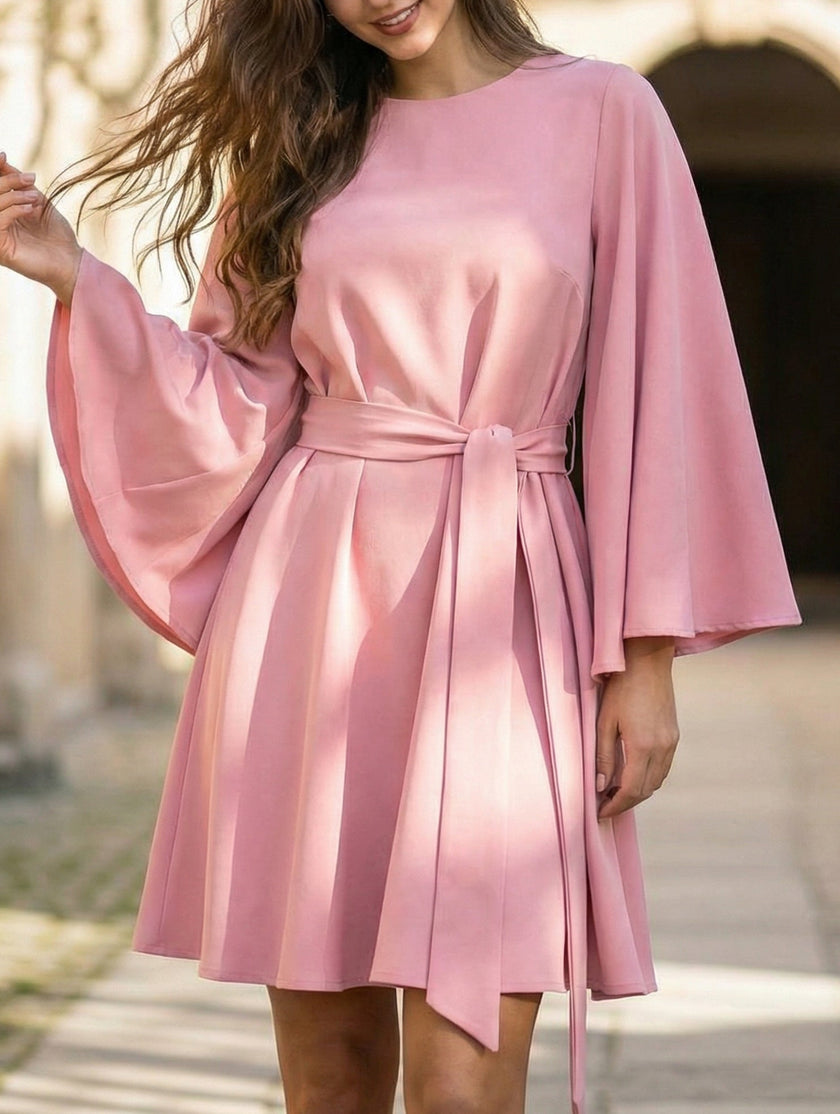 White flared sleeve belted dress by FJØRNA featuring a round neckline, stylish design, and elegant fit.