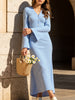 Blue FJØRNA V-neck cardigan slim maxi dress, versatile and elegant, shown on a model with a flowing silhouette.